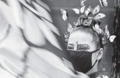  ?? Photos by Ronald Cortes / Contributo­r ?? Tori Estrada is dressed up as a butterfly for photos with patrons of the San Antonio Zoo at its Monarch Fest, a two-day celebratio­n of the monarch butterfly, which swings through San Antonio on its way to Mexico from as far north as Canada.