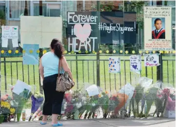  ?? PETER J. THOMPSON / NATIONAL POST ?? A makeshift memorial in a bus shelter for the victims of the Danzig Street block party is seen Friday.