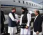  ?? ?? Afghanista­n’s acting Foreign Minister Amir Khan Muttaqi (second right) receives Pakistan’s Foreign Minister Shah Mahmood Qureshi (third left) at the airport in Kabul.