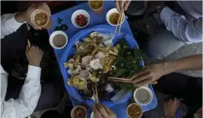  ?? BLOOMBERG PIC ?? Workers eating their lunch in Hanoi. A research firm estimates about 95 per cent of households in Vietnam uses at least one Masan Group consumer product, including fish sauce.