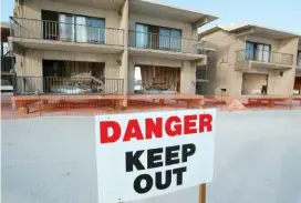  ?? ASSOCIATED PRESS FILE PHOTO ?? A danger sign warns visitors to stay away from the hotel at Gulf State Park in Gulf Shores, Ala., in December 2005. The state has started constructi­on on a beachfront hotel and conference center using money from the BP oil spill.