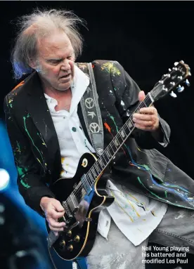  ??  ?? Neil Young playing his battered and modified Les Paul