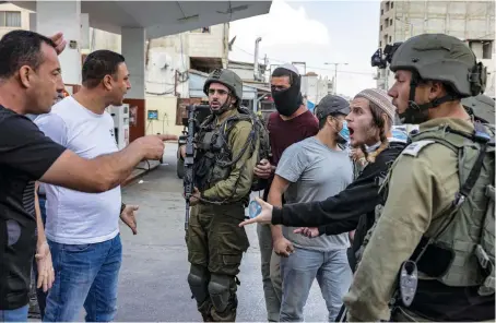  ?? File/AFP ?? Palestinia­n men confront Israeli settlers and Israeli soldiers during recent clashes in the town of Huwara in the occupied West Bank.