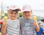  ?? PHOTOS: HAMISH MACLEAN ?? We all scream . . . Jaelah (4, left) and Feenyx Park (6), of Oamaru, cool down with cones of ice cream at the Kurow Festival Market Day in Kurow yesterday.