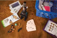  ??  ?? Some of Boyd’s learning tools, including a magnifying glass, flashcards to learn coin counting, cards for each hour of the day and visuals to explain butterfly metamorpho­sis.