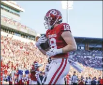  ?? Associated Press ?? Oklahoma tight end Austin Stogner (18) runs in for a touchdown during the second half of an NCAA college football game against Texas Tech on Oct. 30 in Norman, Okla. Oklahoma won 52-21.