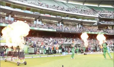  ?? THEO KARANIKOS/AFP ?? Players walk onto the pitch before a Big Bash match at the MCG on January 24, 2016. ECB chiefs believe they need a T20 tournament having seen the success of Australia’s city-based Big Bash.