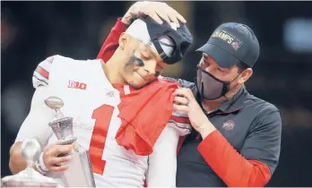  ?? CHRIS GRAYTHEN/GETTY ?? OSU’s Justin Fields, left, and head coach Ryan Day react after defeating Clemson in the College Football Playoff semifinals in New Orleans, Louisiana.