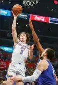  ?? ?? Oklahoma City Thunder guard Josh Giddey (3) shoots against Los Angeles Clippers forward Kawhi Leonard, back right, during the first half of an NBA basketball game in Los Angeles. (AP)