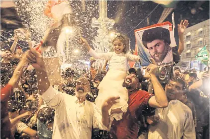  ?? REUTERS ?? Iraqi supporters of Moqtada Sadr’s movement celebrate after preliminar­y results of Iraq’s parliament­ary election were announced in Najaf on Monday.