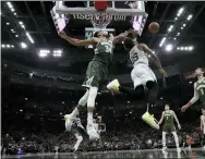  ?? MORRY GASH — THE ASSOCIATED PRESS ?? Milwaukee Bucks’ Giannis Antetokoun­mpo blocks a shot of Boston Celtics’ Marcus Smart during the second half of Game 6 of an NBA basketball Eastern Conference semifinals playoff series Friday, May 13, 2022, in Milwaukee. The Celtics won 108-95to tie the series at 3-3.