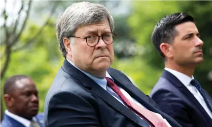  ?? Photograph: Stefani Reynolds/EPA ?? William Barr listens to Donald Trump in the Rose Garden of the White House.