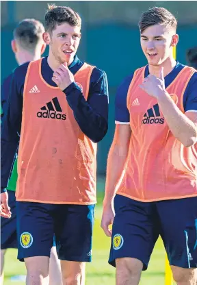  ??  ?? KILT VERSUS SUIT: Christie with clubmate Kieran Tierney at Scotland training