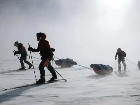  ?? Photo: Keith Parsons ?? GRUELLING: Bridget Kruger (front) and other members of the New Zealand Antarctic Heritage Trust Inspiring Explorers Expedition, tow their 60kg sleds across the Greenland Ice Cap.