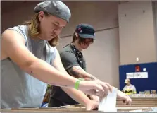  ?? Ryan Painter /The Signal ?? Josh Singer and Sean Rischar sift through a crate of rare comic books at College of the Canyons on Sunday.