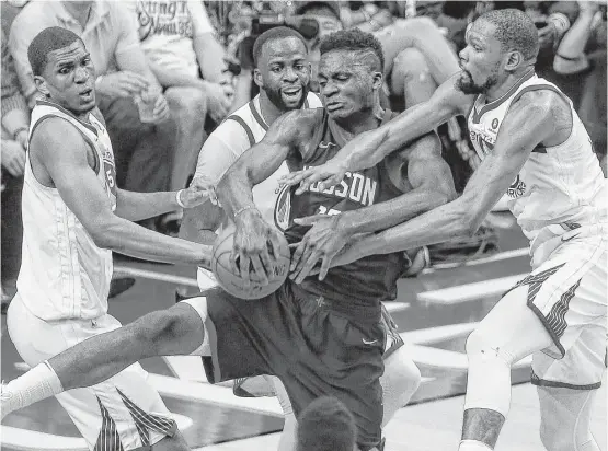  ?? Michael Ciaglo / Houston Chronicle ?? Rockets center Clint Capela gets entangled with, from left, the Warriors’ Kevon Looney, Draymond Green and Kevin Durant in the battle for a second-half rebound.