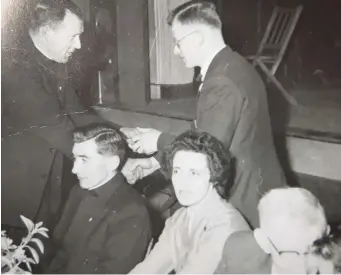  ??  ?? Fr Kevin Connolly, President Lourdes AC, makes an award to John Walkin, a native of Ballina, Co Mayo, at a Lourdes event in 1958. John worked in Connolly Brothers during his time in the town and also competed with the Lourdes club. Pictured at the front is Fr Quinn CC.