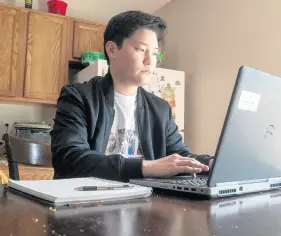  ?? ANDY LAVALLEY/POST-TRIBUNE ?? Valparaiso University engineerin­g senior Ben Kontney works in his apartment in Valparaiso on March 31. Kontney is president of the Asian American Pacific Islander Coalition at Valparaiso. University.