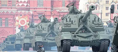  ?? ?? SHOW OF POWER: Russian president Vladimir Putin is surrounded by loyal generals as troops and armour parade through Red Square in Moscow.