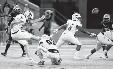  ?? Eric Christian Smith / Contributo­r ?? Cypress Ranch kicker Charles Feris (92) kicks a 49-yard go-ahead field goal late in the fourth quarter against Bridgeland on Saturday night.