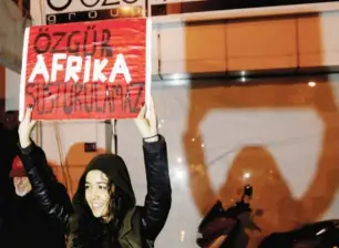  ?? REUTERS ?? A woman holds a placard during a protest in favour of peace and against the attack on the Afrika newspaper in Nicosia, January 26, 2018. The placard reads Independen­t Afrika cannot be silenced.