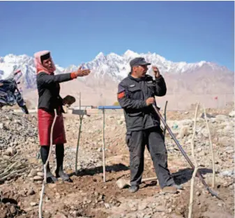  ??  ?? Locals plant sea buckthorn in Xindie Village. The village had officially been lifted out of poverty by 2017. But locals were not content and still desired to expand their road to prosperity.