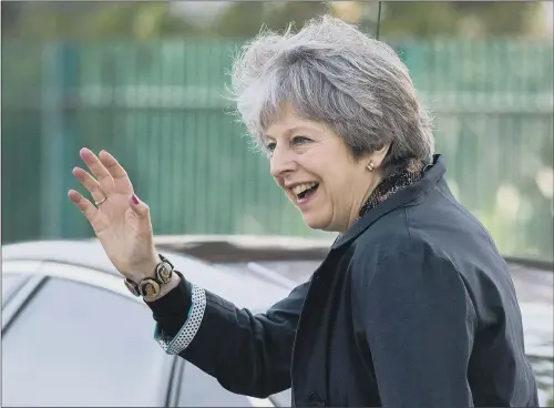  ?? PICTURES: OLI SCARFF/PA WIRE. ?? DEFENDING TARGETS: Prime Minister Theresa May waves as she leaves after visiting Brooklands Primary School in Sale, near Manchester, yesterday.