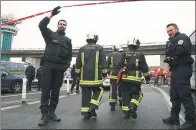  ?? CHRISTIAN HARTMANN / REUTERS ?? Emergency workers are seen at Paris Orly airport on Saturday, where a man tried to seize a soldier’s rifle, saying he wanted to “die for Allah”, before other soldiers shot him dead, officials said. Flights were returning to normal on Sunday.