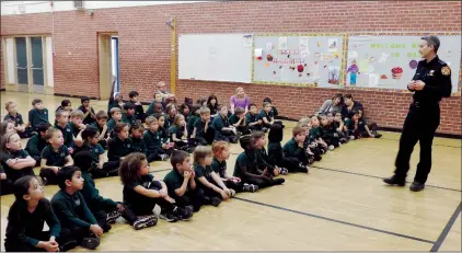  ?? NEWS PHOTO CHRIS BROWN ?? Fire prevention officer Carter Gramlich speaks Wednesday to students at CAPE School. Gramlich and others are visiting schools during Fire Prevention Week, Oct. 7-13, to teach them about preventing fires and what to do if one breaks out.