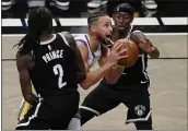  ?? KATHY WILLENS — THE ASSOCIATED PRESS ?? Nets forward Taurean Prince (2) and guard Caris LeVert (22) defend Warriors guard Stephen Curry (30) as Curry looks to shoot during the first quarter on Tuesday in New York.