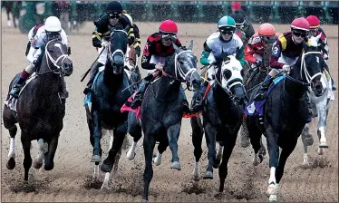  ?? The Sentinel-Record/RICHARD RASMUSSEN ?? Morning-line favorite Unconteste­d (far right), ridden by jockey Channing Hill, leads a field of 12 horses into the first turn during the $500,000 Southwest Stakes on Monday at Oaklawn Park in Hot Springs. One Liner, with jockey John Velazquez (far...