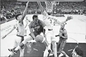  ?? AP Photo/Mark J. Terrill ?? Los Angeles Clippers guard Reggie Jackson, second from left, tries to pass while under pressure from Los Angeles Lakers guard Danny Green, left, and forward Anthony Davis Sunday in Los Angeles.