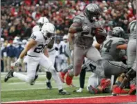  ?? JAY LAPRETE — THE ASSOCIATED PRESS ?? Ohio State running back Mike Weber, right, scores a touchdown against Penn State during the first half of an NCAA college football game Saturday in Columbus, Ohio.