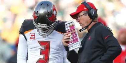  ?? | AP ?? Coach Dirk Koetter ( with quarterbac­k Jameis Winston) reportedly will return to coach the Buccaneers for a third season.