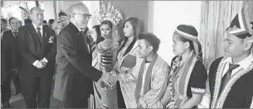  ??  ?? Riot ( second left) greeting graduates in traditiona­l costumes. Following behind him is Peter.