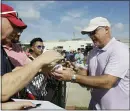  ?? JEFF ROBERSON — THE ASSOCIATED PRESS ?? Washington Nationals general manager Mike Rizzo, right, signs autographs for fans during spring training baseball practice Friday, Feb. 14, 2020, in West Palm Beach, Fla.