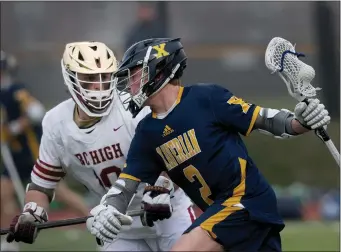  ?? NANCY LANE — BOSTON HERALD ?? Xaverian’s Charles Brennan tries to get past BC High’s Josh LaPointe during BC High’s 12-10boys lacrosse win.