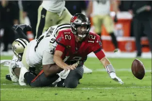 ?? MARK LOMOGLIO — THE ASSOCIATED PRESS ?? Tampa Bay Buccaneers quarterbac­k Tom Brady (12) fumbles after a hit by New Orleans Saints defensive end Cameron Jordan (94) and cornerback P.J. Williams (26) during the second half of the Saints’ 9-0 win over the Bucs.