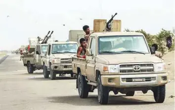  ?? AFP ?? A convoy of Yemeni fighters of the Amalqa (Giants) Brigades, loyal to the Saudi-backed government, prepares to join the offensive to seize the Red Sea port city of Hodeida.