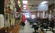  ?? STAFF PHOTO By Greg Bischof ?? ■ Customers wait at the serving counter at TLC Burger & Fries, 201 East Broad Street, to pay for their carry-out orders. Like other Texarkana restaurant­s, TLC has had to temporaril­y close its dine-in operations and provide only carry-out meals.