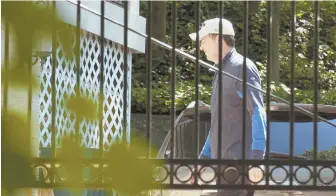  ??  ?? OUT OF A JOB: Former FBI Director James B. Comey walks at his home in McLean, Va., after he was fired by President Trump on Tuesday.