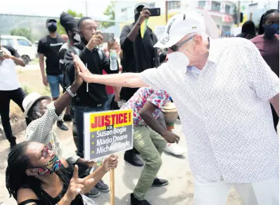  ?? GLADSTONE TAYLOR/MULTIMEDIA PHOTO EDITOR ?? United States Ambassador Donald Tapia greets protesters gathered in front of the American Embassy on Hope Road in St Andrew yesterday in solidarity with African Americans taking a stand against racial injustices in the US. They also used the event to call for justice for some fellow Jamaicans who lost their lives under controvers­ial circumstan­ces.