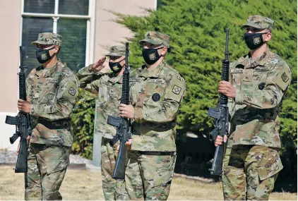  ?? MATT DAHLSEID/THE NEW MEXICAN ?? Members of the New Mexico National Guard perform a three-rifle volley Friday during a ceremony recognizin­g the 79th anniversar­y of the fall of Bataan, outside the Bataan Memorial Building.