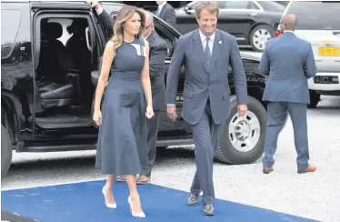  ??  ?? US first lady Melania Trump arrives at the Queen Elisabeth Music Chapel in Waterloo, Belgium, during a spouses program on the sidelines of the NATO summit yesterday, and (inset) husband Donald Trump with PM Theresa May