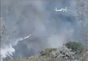  ?? JOSE CARLOS FAJARDO — STAFF ARCHIVES ?? A helicopter drops water while battling the Glass Fire in St. Helena on Sept. 27, 2020. Jet fuel shortages could hamper firefighti­ng during a busy wildfire season in the western United States.