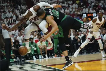  ?? LYNNE SLADKY — THE ASSOCIATED PRESS ?? Heat forward Jimmy Butler, left, and Celtics forward Grant Williams go after a loose ball during Game 5on Wednesday.