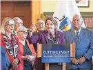  ?? ?? Gov. Maura Healey speaks in the State Library on Wednesday after signing a tax relief bill into law, joined by top lawmakers including, at far left, Senate President Karen Spilka and, far right, House Speaker Ronald Mariano.