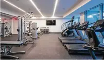  ?? Photo courtesy of The Wilshire ?? Luxury high-rises are full of amenities for residents to enjoy and to simplify their lives. Shown is the fitness center at The Wilshire.