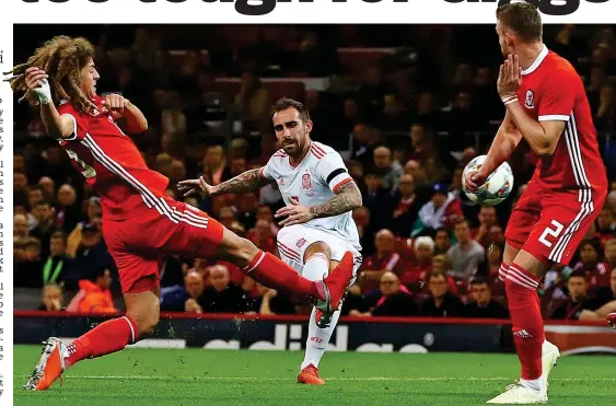  ?? BPI/REX ?? Early setback: Alcacer curls the ball home after eight minutes as Spain prove far too strong for Wales last night