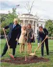  ?? ANDREW HARNIK/AP ?? French President Emmanuel Macron, right, planting a tree at the White House last April with President Donald Trump, gave him an 18th century map of the United States.